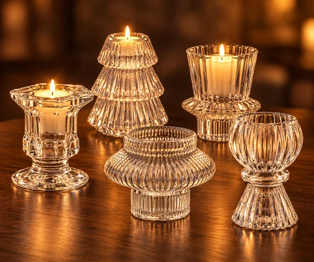 Sculptural ribbed clear glass candle holders, including a tree-shaped holder, displayed in warm candlelight